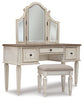 Realyn Queen Upholstery Panel Bed, Dresser, Chest, Nightstand, and Vanity Set