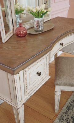 Realyn Queen Upholstery Panel Bed, Dresser, Chest, Nightstand, and Vanity Set